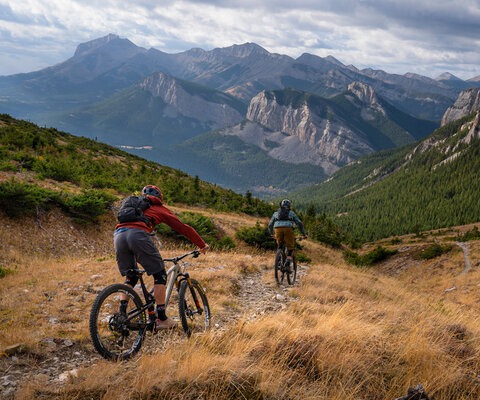 Sam Schultz and Eric Melson descend a particularly scenic section of backcountry singletrack near Montana’s Bob Marshall Wilderness Complex in late autumn.