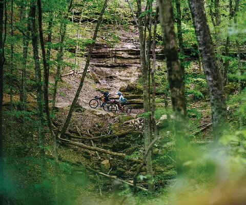 Kaysee Armstrong and Corie Spruill make their way through a 180-mile journey in the Ozark Mountains. After a helicopter dropped the group at Trigger Gap airstrip, they planned to ride for six days through the vast expanse of rolling backcountry hills.